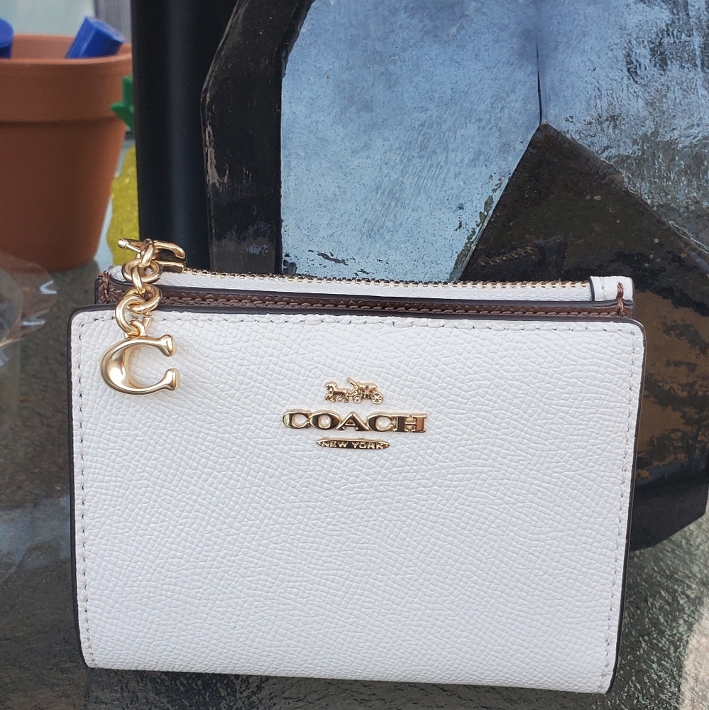 Coach™️ Leather Fold Wallet with Snap Closure